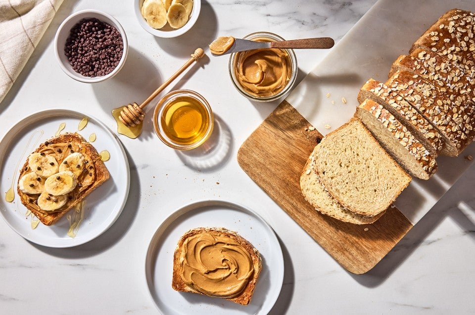 Back-of-the-Bag Oatmeal Bread served with peanut butter, bananas, and honey - select to zoom