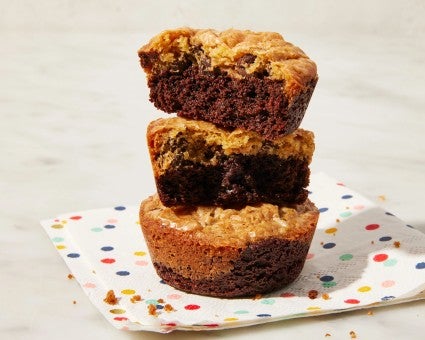 Stack of three brownie cookies on a colorful napkin. 