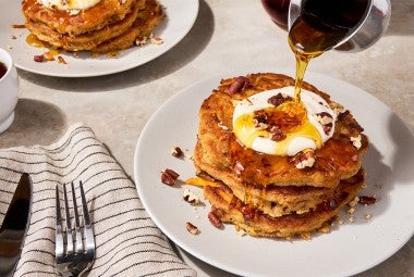 Carrot Cake Pancakes on a plate with syrup pouring over them