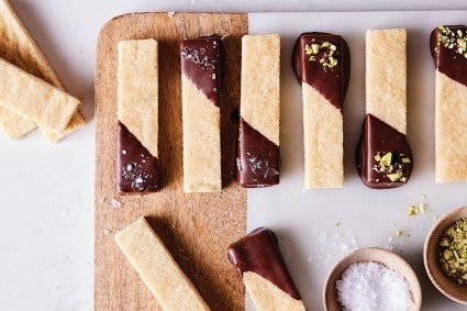 Bars of shortbread dipped in tempered chocolate and sprinkled with salt and pistachios